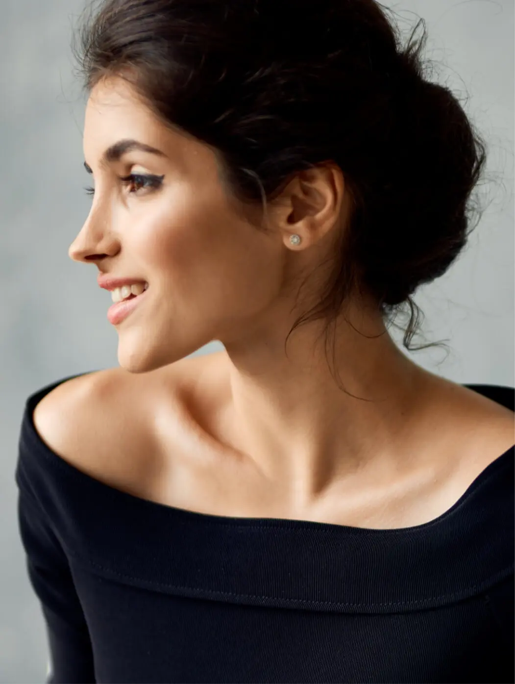 Model wearing black dress smiling