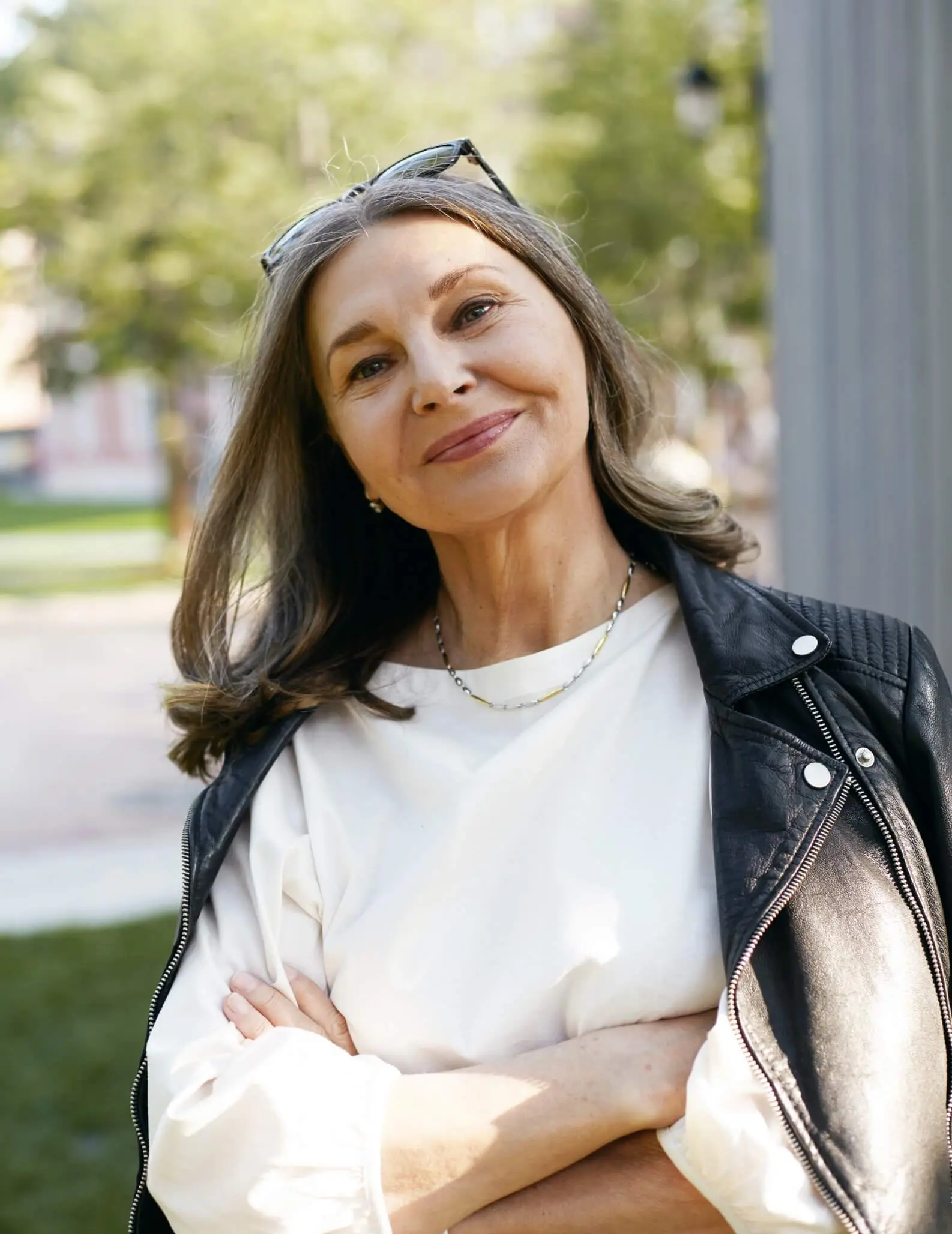 Beautiful, older woman smiling with her arms crossed