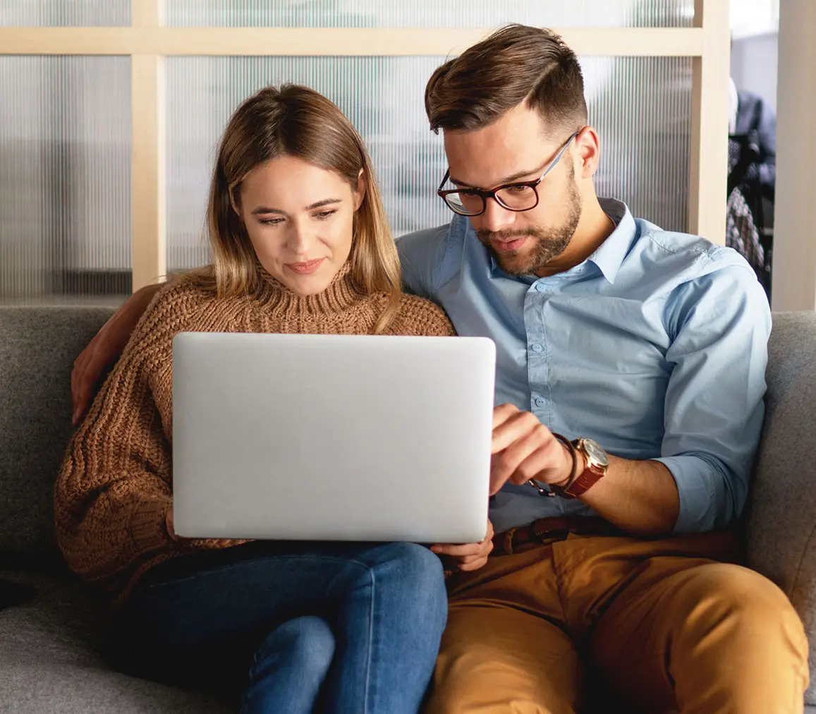 Young smiling couple looking for something online