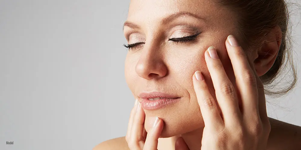 Female touching her face with both hands