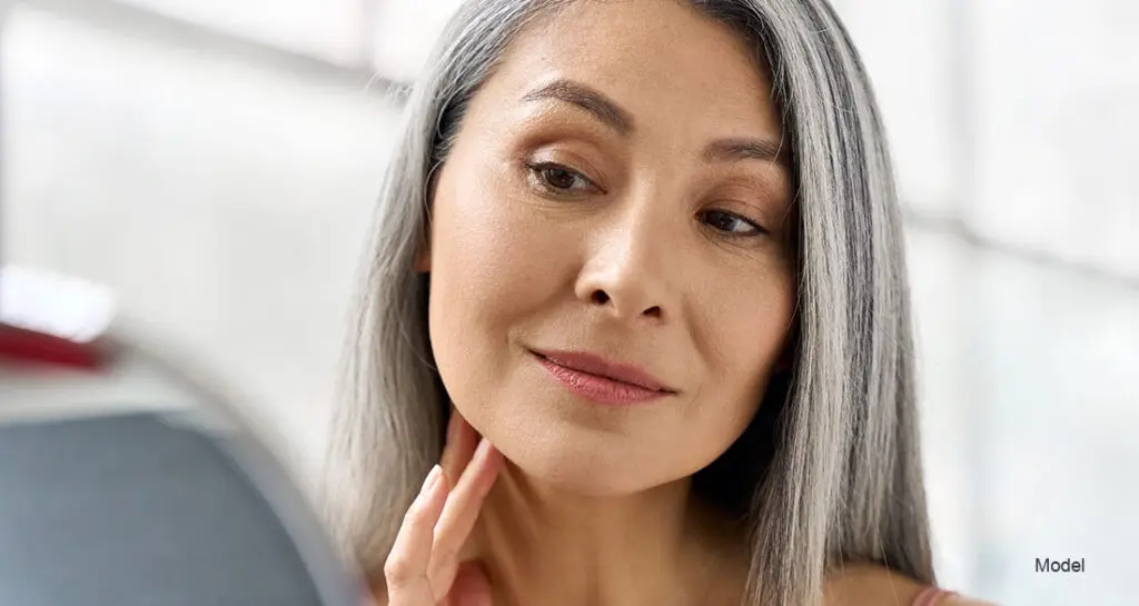 woman looking at herself in the mirror