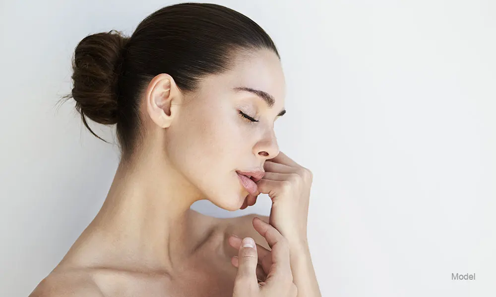 Profile woman touching her face